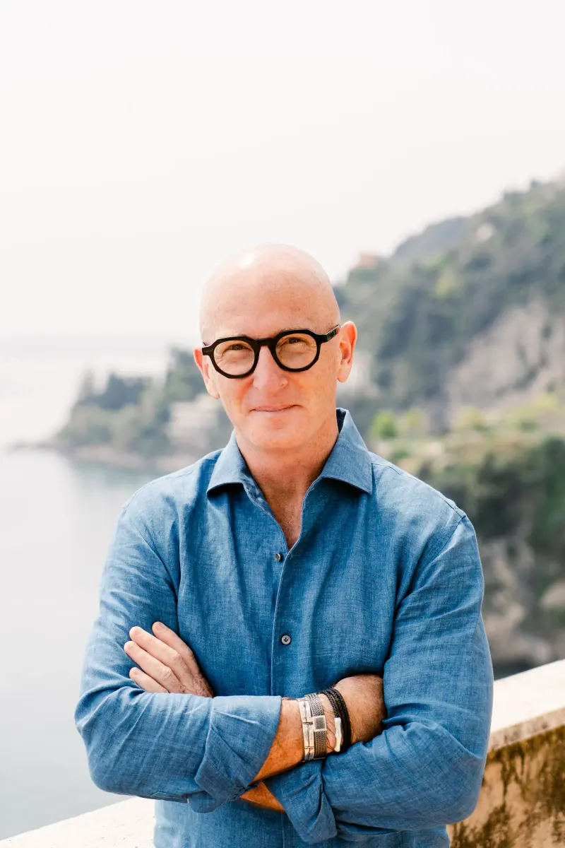 Errol Damelin, founder of Dust Road Ventures, photographed in coastal linen, golden hour.